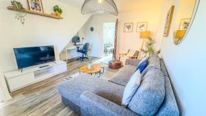a living room with a blue couch and a tv at 3BR House Near Cardiff Bay City Centre and Stadium with Free Parking in Cardiff