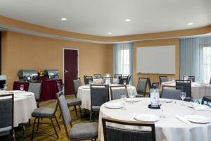 a conference room with tables and chairs and a whiteboard at Courtyard by Marriott Jacksonville I-295/East Beltway in Jacksonville +45 photos