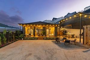 a house with a patio with lights on it at Bin Home in Ấp Kim Thạch