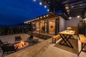 an outdoor patio with a table and a fire pit at Bin Home in Ấp Kim Thạch