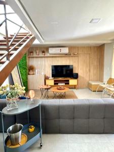 a living room with a couch and a television at Casa Amaré Barreirinhas in Barreirinhas