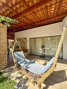 a hanging hammock in a patio with a building at Casa Amaré Barreirinhas in Barreirinhas