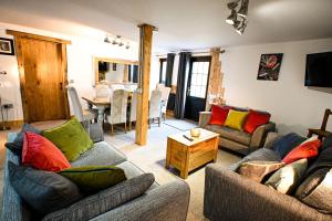 a living room with two couches and a table at Eeyore's Place in Hythe