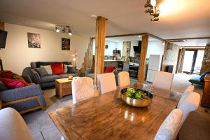 a dining room and living room with a table and chairs at Eeyore's Place in Hythe
