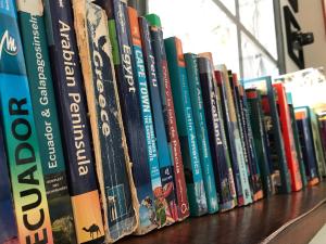 a row of books sitting on a shelf at El Caracol in Popayan