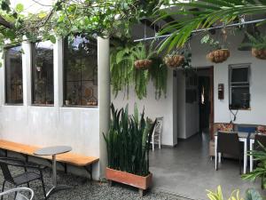 a patio with a table and chairs and plants at El Caracol in Popayan