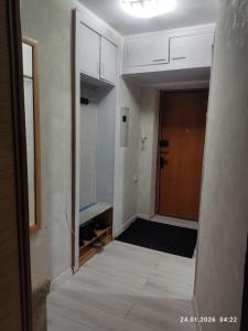 an empty hallway with a door and a room at Бухар жырау 45 in Karagandy