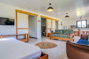 a living room with a bed and a couch at Moorea Maatea Tahatai Lodge in Moorea