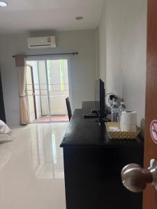 a room with a desk with a computer on it at บ้านทรัพย์มงคล Baansupmongkol krabi in Ban Nua Khlong