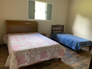 a bedroom with two beds and a window at Sítio Canario da Terra in Gonçalves