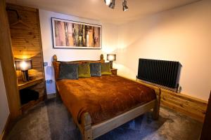 a bedroom with a bed with two lamps and a radiator at Pooh Corner in Hythe