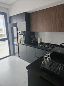 a kitchen with a black counter top and a stove at loft in El Aouina Station