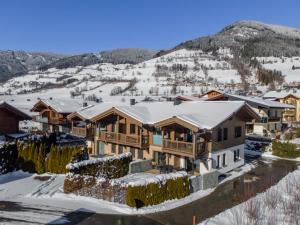 an aerial view of a resort in the snow at BergbiberLODGE L in Piesendorf