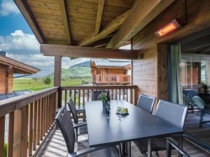 a dining table on the deck of a cabin at BergbiberLODGE L in Piesendorf