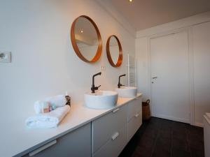 two sinks in a bathroom with two mirrors at LOFT-54 -Exclusive Apartment with Terrace in Zwevegem +31 photos