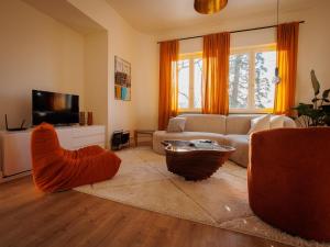 a living room with a couch and a tv at LOFT-54 -Exclusive Apartment with Terrace in Zwevegem