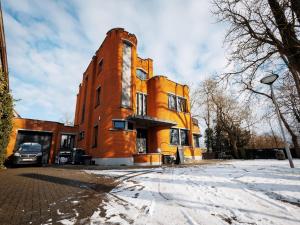 a large brick building with snow on the ground at LOFT-54 -Exclusive Apartment with Terrace in Zwevegem