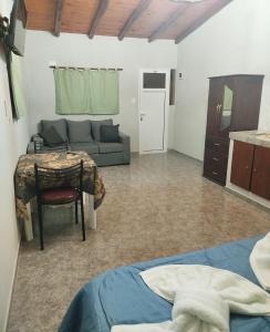 a living room with a couch and a table at Monoambiente Pilu in Villa Cura Brochero