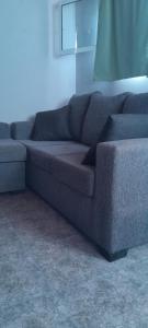 a blue couch sitting in a living room at Monoambiente Pilu in Villa Cura Brochero