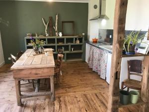 a dining room with a wooden table and a kitchen at Hilltop Haven in Parlan in Parlan +31 photos