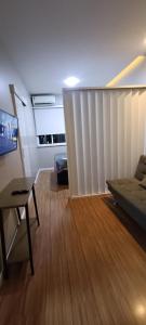 a living room with a bed and a table and a couch at Loft Dream Rest in Teresópolis