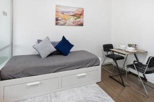 a bedroom with a bed with a table and chairs at Spacious 1BR wSofa Bed Pool Gym 1Gbps Wi-Fi in Kathu