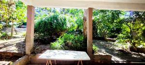 a porch with a bench in the middle of a yard at Chalet para desconectar in Piriápolis
