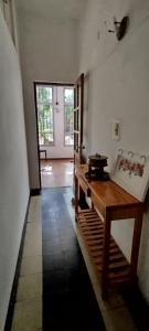 a room with a wooden table and a door at Chalet para desconectar in Piriápolis