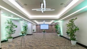 a large room with potted plants and a projection screen at Crowne Plaza Santo Domingo by IHG in Santo Domingo +96 photos