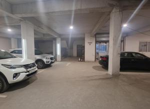 a parking garage with several cars parked in it at Arohan stay in Ayodhya