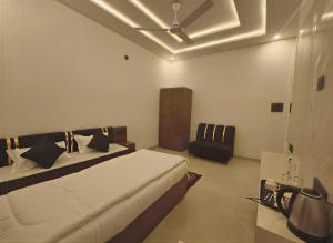 a bedroom with a bed and a ceiling fan at Arohan stay in Ayodhya
