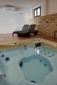 eine Whirlpool-Badewanne in einem Zimmer mit Klavier in der Unterkunft Vilars 10 in Espolla