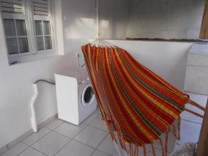 a washing machine in a bathroom with a towel at Frédovacances logement iGloo-LOVE in Rivière-Pilote