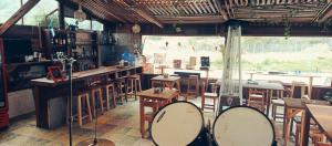 a bar with wooden tables and chairs in a room at Raíces de Papallacta in Papallacta