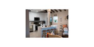 a kitchen and living room with a counter and chairs at Shared Space in SoSo Coastal Retreat in West Palm Beach