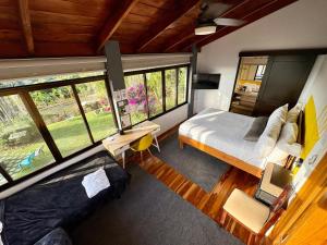 a bedroom with a bed and a large window at Hotel Honey Bee in Alajuela +117 photos