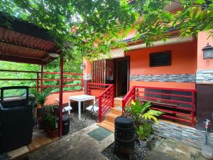 a porch of a house with a bench and a table at Little Apple Inn in San Juan