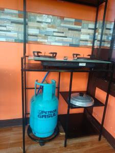 a bathroom with a blue tank under a sink at Little Apple Inn in San Juan