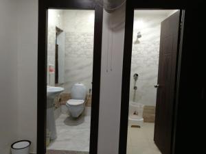 a bathroom with a toilet and a sink at Hotel Confirm Inn Kota in Kota