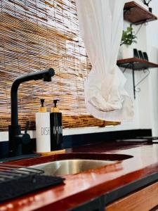 a kitchen counter with a sink and a window at Studio Vellae in Corinthe +24 photos