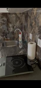 a kitchen counter with a stove and a roll of paper towels at Apartments Budva Sunset in Budva
