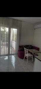 a living room with a couch and a table at Apartments Budva Sunset in Budva