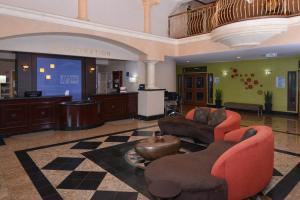 a lobby with two chairs and a reception desk at Holiday Inn Express Hotel & Suites El Centro by IHG in El Centro +39 photos