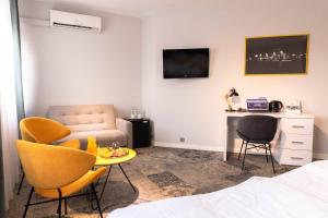 a bedroom with a bed and a table and chairs at Hotel Nafta Krosno in Krosno