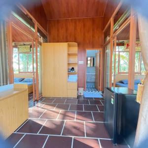 a kitchen with a tiled floor and wooden walls at Melalueca tây ninh in Tây Ninh