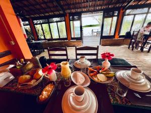 a table with food on it in a restaurant at Pousada e Restaurante do Paulo in Jijoca de Jericoacoara +61 photos