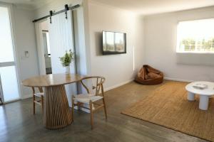 a living room with a table and a table and chairs at Dreamy Staiz - Riverland Abode in Barmera