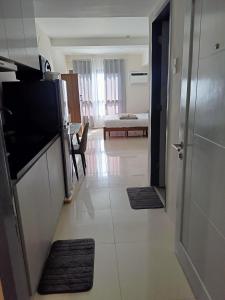 a room with a kitchen and a living room at Homey studio in jtower residences in Mandaue City