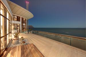 a balcony of a building with a view of the ocean at Ocean View Penthouse in Strand