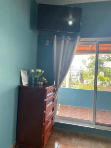 a blue room with a dresser and a window at Refugio del Mar in Puerto Escondido